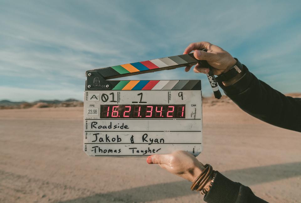 A clapperboard held up on location